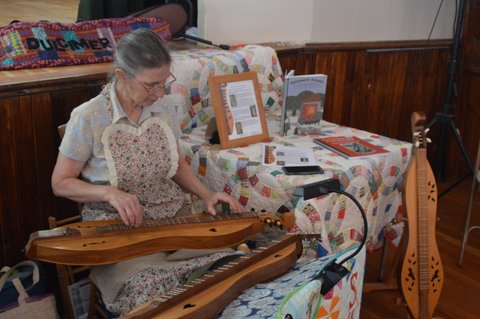 Playing dulcimer at quilt show